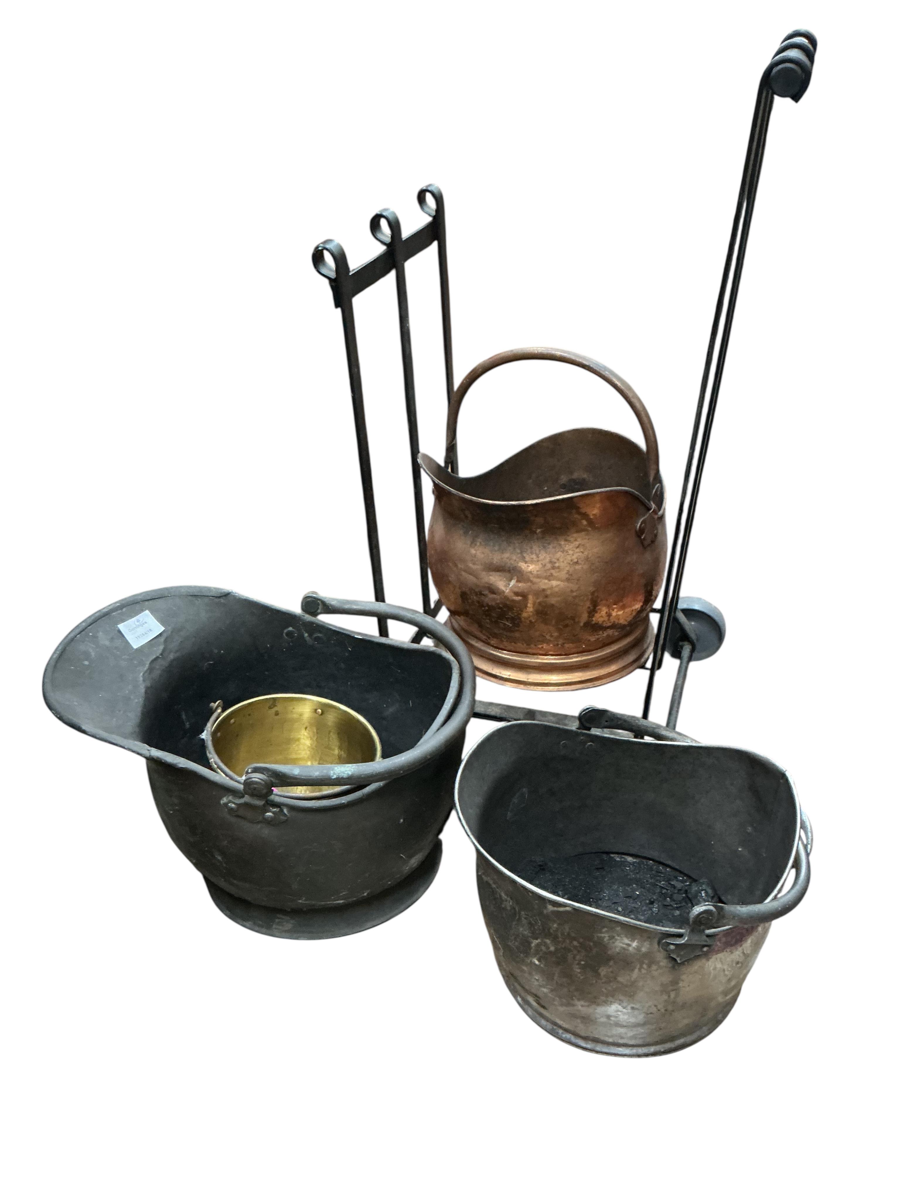 A wrought iron log stand, three copper and iron coal scuttles and a small brass pail